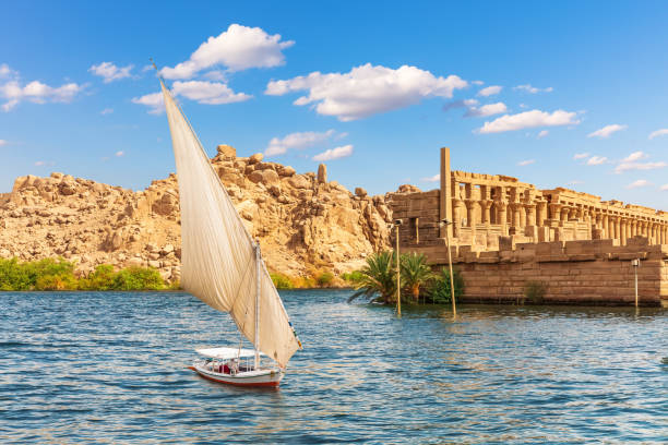 Felucca by the Temple of Philae on the Agilikia island, the Nile, Aswan, Egypt.